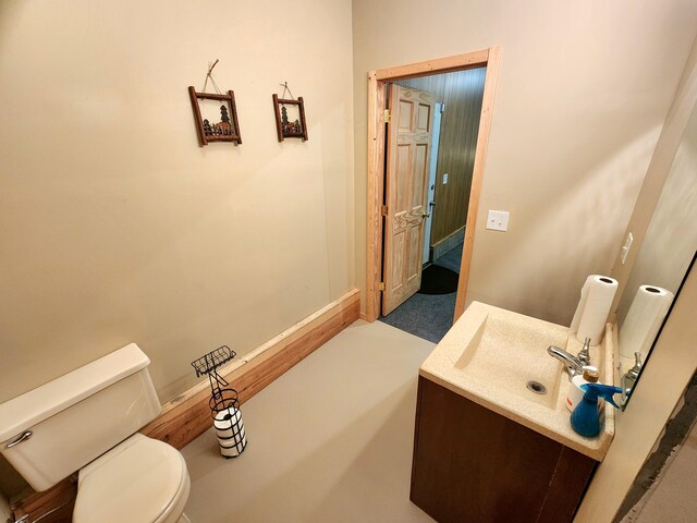 6039 W Morris Lake Rd, Mears, MI 49436 - bathroom with baseboards, vanity, and toilet