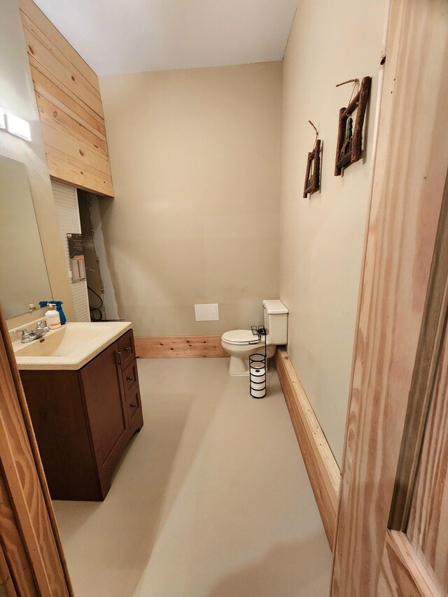 6039 W Morris Lake Rd, Mears, MI 49436 - half bathroom featuring vanity, finished concrete flooring, and toilet