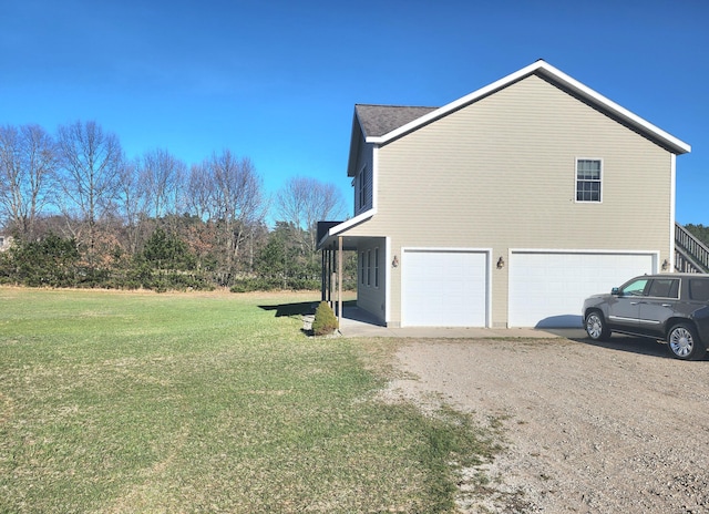 6039 W Morris Lake Rd, Mears, MI 49436 - view of side of property featuring dirt driveway, a yard, and a garage