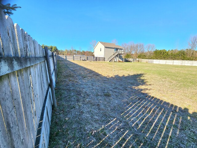 6039 W Morris Lake Rd, Mears, MI 49436 - view of yard featuring a fenced backyard and stairway