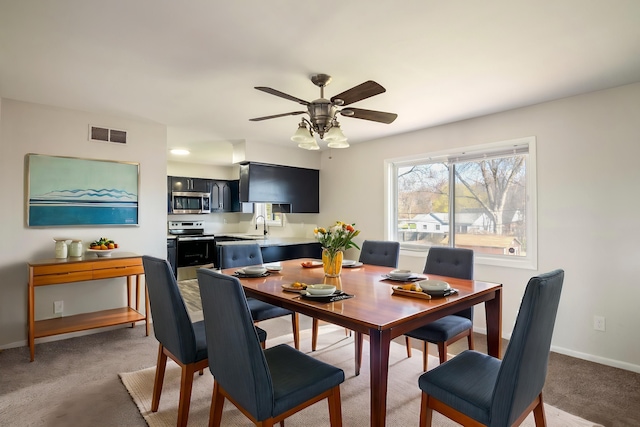 20100 Wick Rd, Taylor, MI 48180 - dining room with light carpet, baseboards, visible vents, and ceiling fan