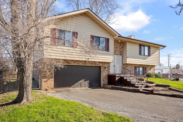 20100 Wick Rd, Taylor, MI 48180 - raised ranch with brick siding, fence, aphalt driveway, and a garage