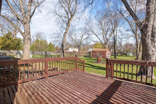 20100 Wick Rd, Taylor, MI 48180 - wooden deck featuring a storage unit, a lawn, a fenced backyard, and an outbuilding