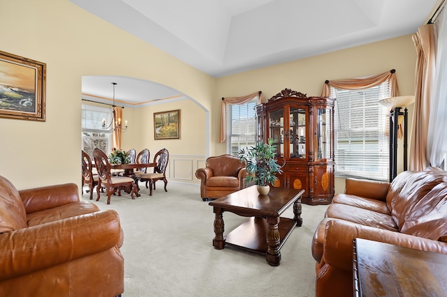 7511 Dunross Dr, Portage, MI 49024 - carpeted living area featuring a wainscoted wall, a wealth of natural light, and a chandelier