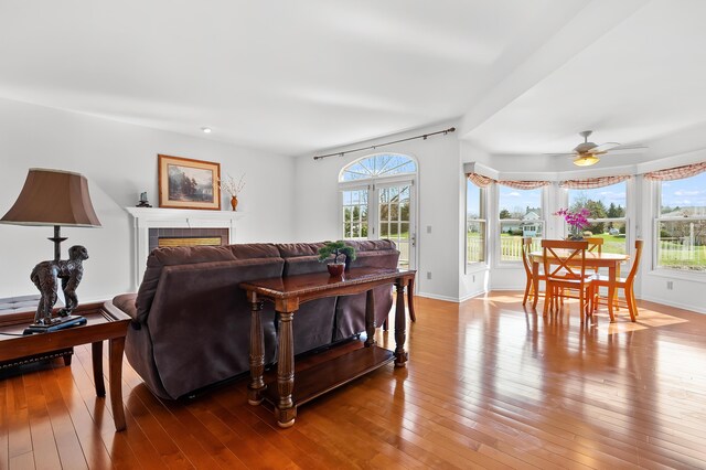 7511 Dunross Dr, Portage, MI 49024 - living area featuring wood-type flooring, a fireplace, baseboards, and ceiling fan