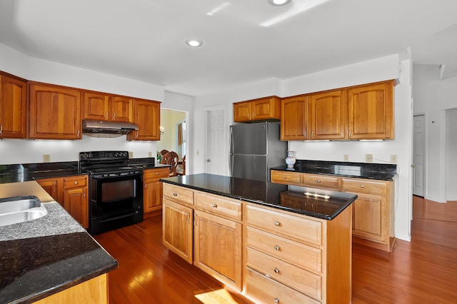 7511 Dunross Dr, Portage, MI 49024 - kitchen with dark wood finished floors, under cabinet range hood, dark stone countertops, freestanding refrigerator, and electric range