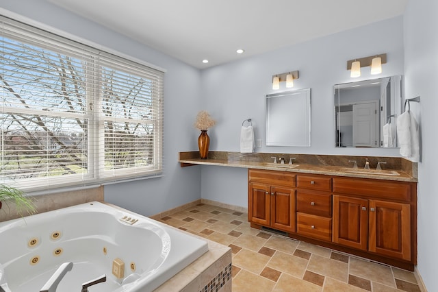 7511 Dunross Dr, Portage, MI 49024 - full bathroom featuring stone finish flooring, a sink, double vanity, and a tub with jets