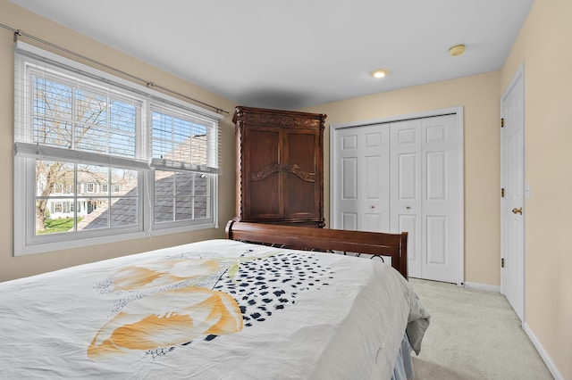 7511 Dunross Dr, Portage, MI 49024 - bedroom featuring a closet, light carpet, baseboards, and multiple windows