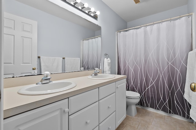 7511 Dunross Dr, Portage, MI 49024 - bathroom featuring double vanity, tile patterned flooring, toilet, and a sink