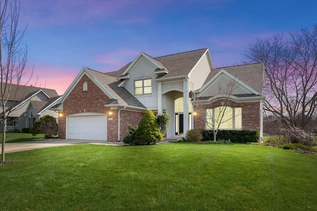 7511 Dunross Dr, Portage, MI 49024 - traditional home featuring concrete driveway, a lawn, a shingled roof, an attached garage, and brick siding