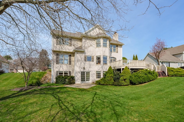 7511 Dunross Dr, Portage, MI 49024 - rear view of house with a lawn, a chimney, and a deck