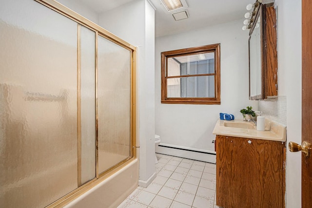 full bath with a baseboard heating unit, tile patterned floors, bath / shower combo with glass door, toilet, and vanity