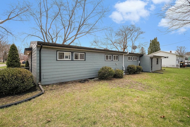 back of property with a lawn