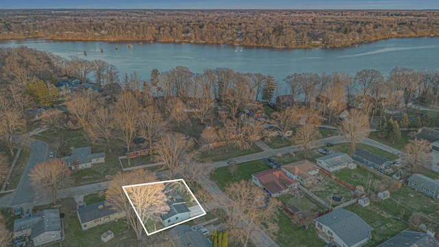 birds eye view of property featuring a forest view, a residential view, and a water view