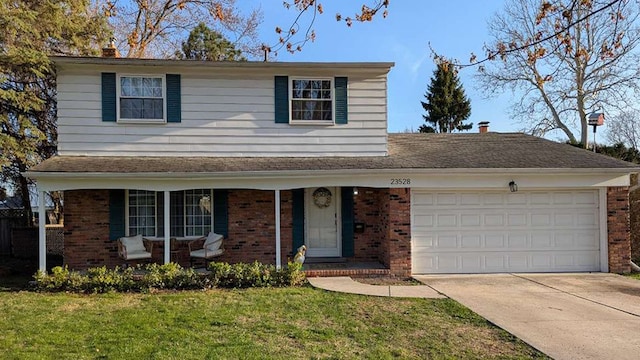 23528 King Dr, Clinton Township, MI 48035 - traditional home featuring driveway, an attached garage, and brick siding