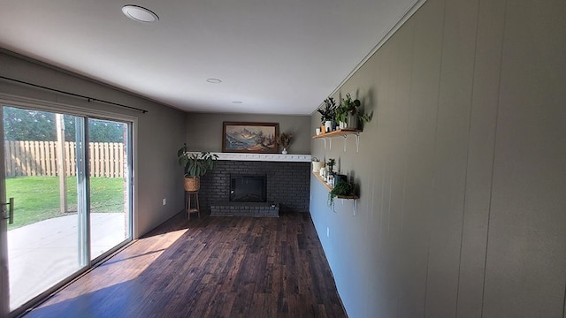 23528 King Dr, Clinton Township, MI 48035 - unfurnished living room with a brick fireplace and dark wood finished floors