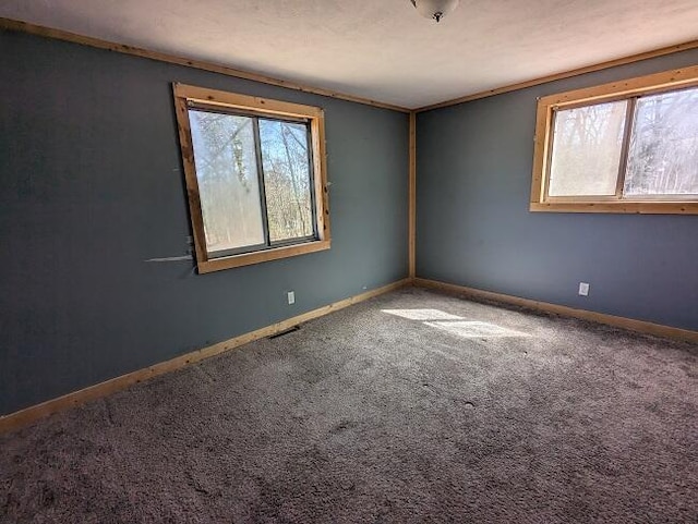 carpeted empty room with baseboards