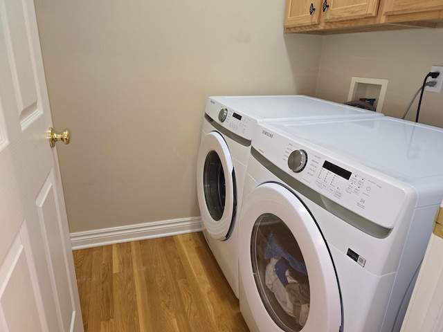 45645 Graystone Ln, Canton, MI 48187 - laundry area featuring cabinet space, washing machine and clothes dryer, light wood finished floors, and baseboards