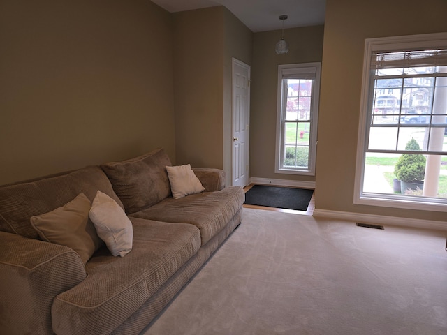 45645 Graystone Ln, Canton, MI 48187 - carpeted living room featuring baseboards and plenty of natural light