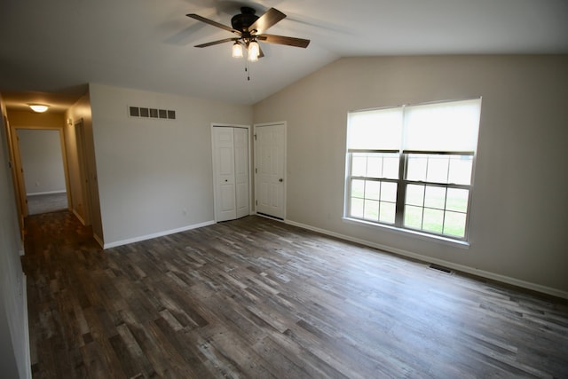 unfurnished bedroom with baseboards, dark wood-style flooring, and visible vents
