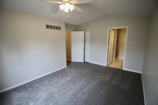 unfurnished bedroom featuring baseboards, visible vents, carpet, lofted ceiling, and a closet