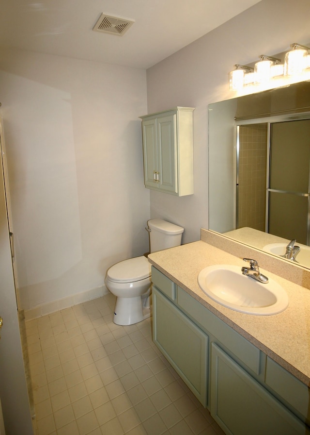 bathroom with tile patterned floors, toilet, visible vents, a shower with door, and vanity