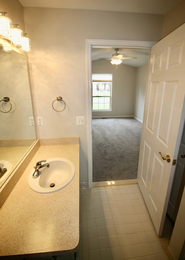 bathroom with baseboards, a ceiling fan, vanity, and tile patterned floors