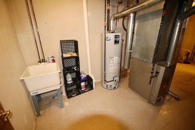 utility room with a sink and gas water heater