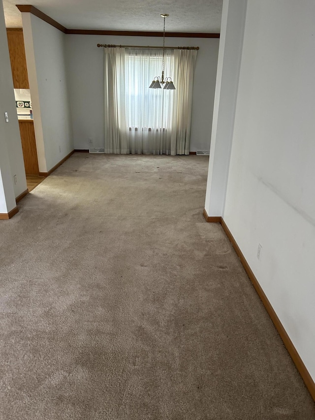 4 Grady Ct, Coldwater, MI 49036 - unfurnished room featuring light colored carpet, a chandelier, and crown molding