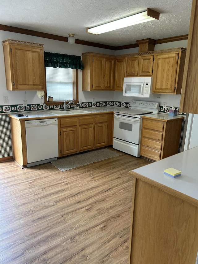 4 Grady Ct, Coldwater, MI 49036 - kitchen with white appliances, a textured ceiling, light countertops, light wood-type flooring, and ornamental molding