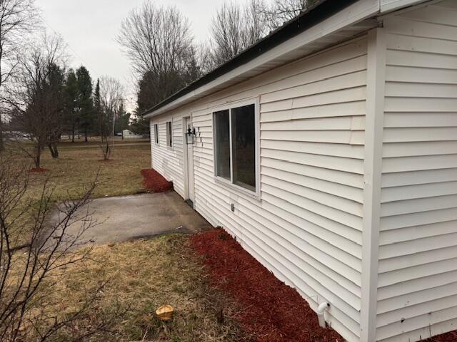 view of side of property with a patio area