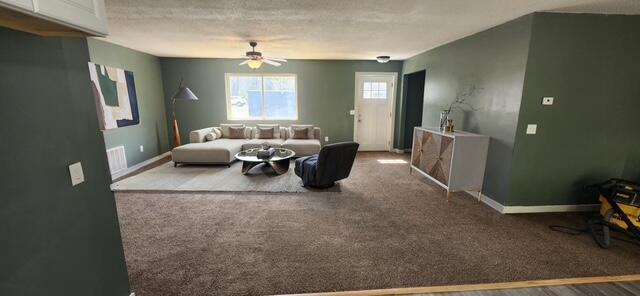 9864 Cadillac Dr, Lake, MI 48632 - living room featuring ceiling fan and baseboards