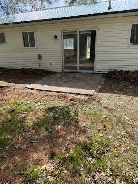 9864 Cadillac Dr, Lake, MI 48632 - back of property with a patio and metal roof
