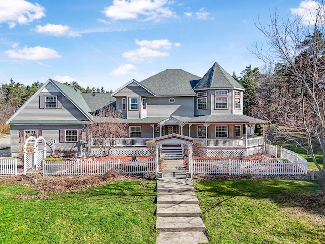 rear view of property featuring a porch, a yard, and fence private yard