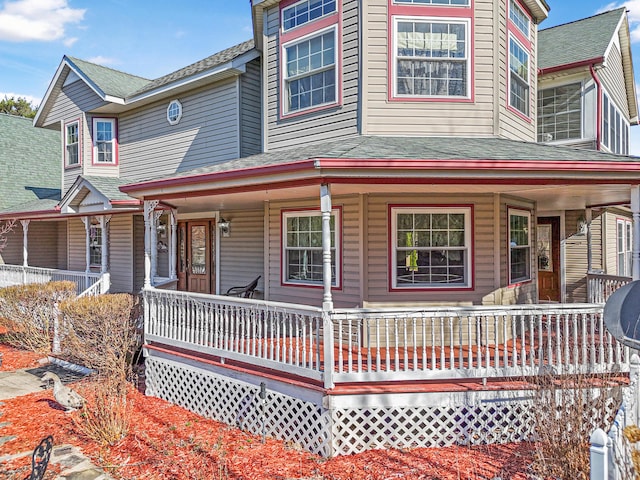 view of front of home featuring a porch and roof with shingles
