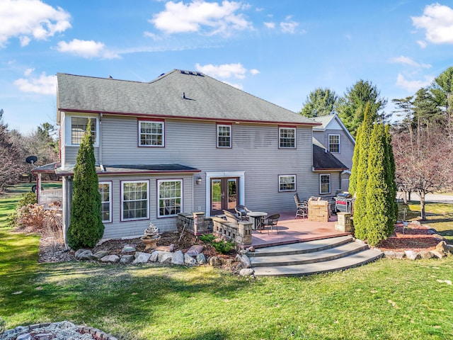 back of property featuring a lawn, a wooden deck, roof with shingles, and french doors