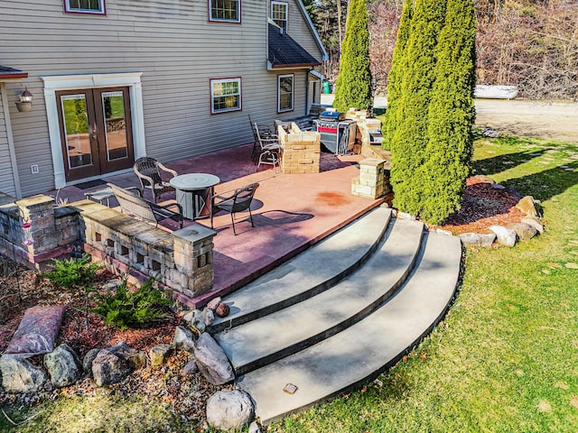 deck with a patio area, a lawn, and french doors