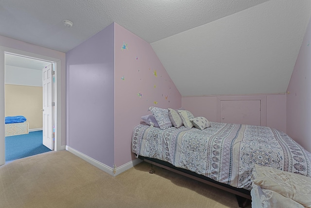 bedroom with carpet flooring, lofted ceiling, and baseboards