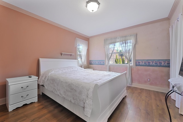 bedroom featuring crown molding, baseboards, and dark wood finished floors