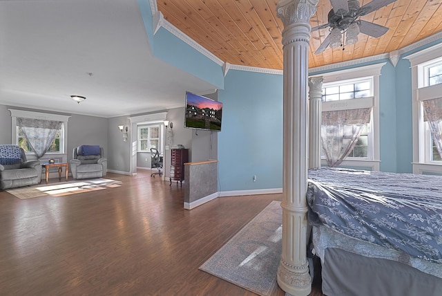 bedroom featuring crown molding, baseboards, and decorative columns