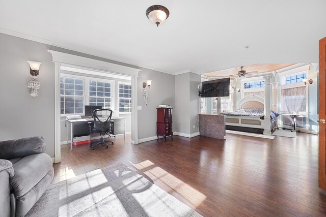 office space featuring ornamental molding, ceiling fan, wood finished floors, and baseboards