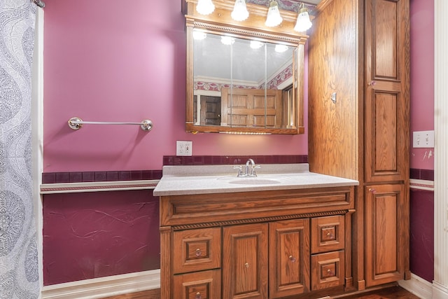 bathroom with crown molding and vanity