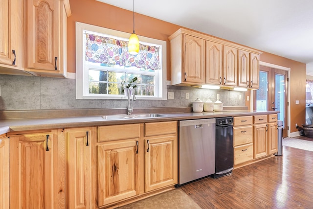 kitchen with a sink, plenty of natural light, light brown cabinetry, dishwasher, and dark wood-style flooring