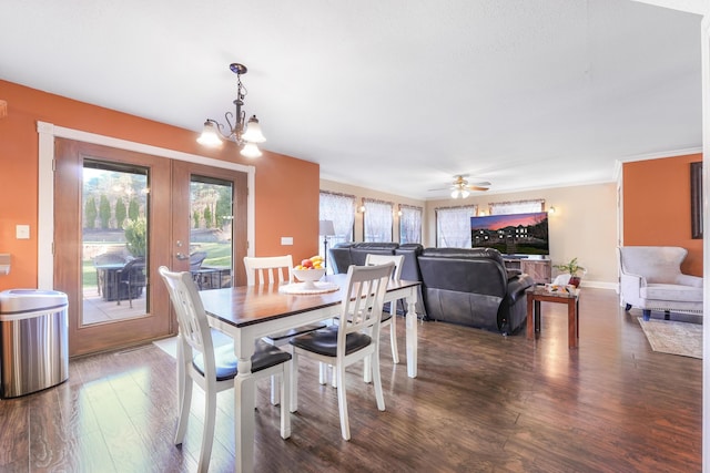 dining area with baseboards, ceiling fan with notable chandelier, and dark wood-type flooring
