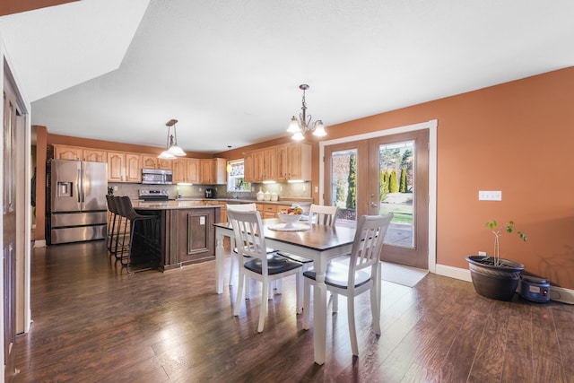 dining room featuring an inviting chandelier, dark wood-style flooring, french doors, and plenty of natural light