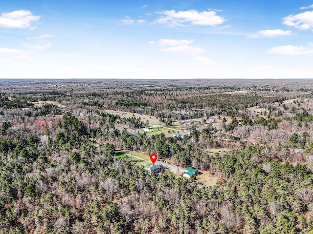 drone / aerial view featuring a view of trees