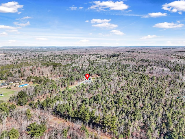 birds eye view of property featuring a wooded view