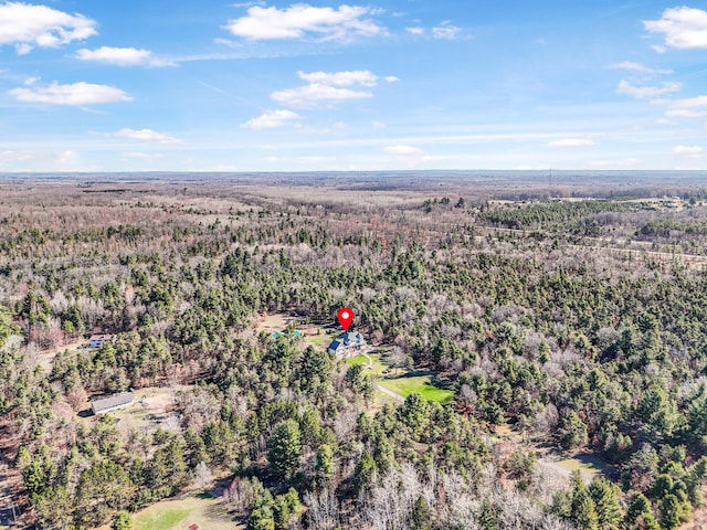 drone / aerial view featuring a wooded view