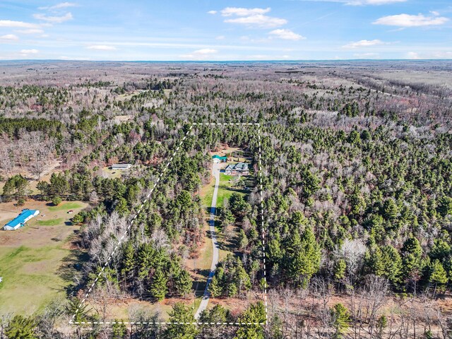 birds eye view of property with a view of trees