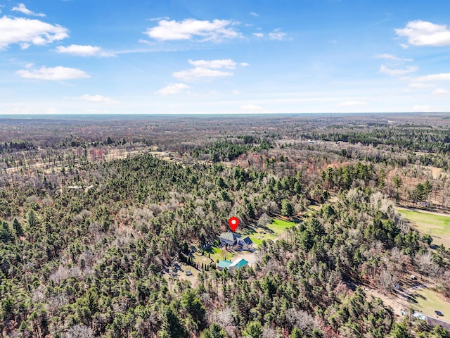 bird's eye view with a wooded view